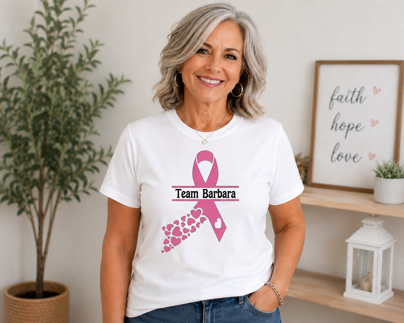 Woman wearing a white custom cancer awareness ribbon t-shirt with Team Barbara text and pink hearts